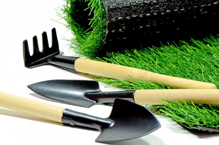 Small Gardening Tools and Artificial Turf Isolated on White Background.
